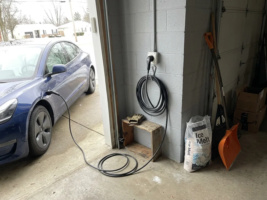 Finished NEMA 14-50 outlet with a portable Level 2 charger plugged in