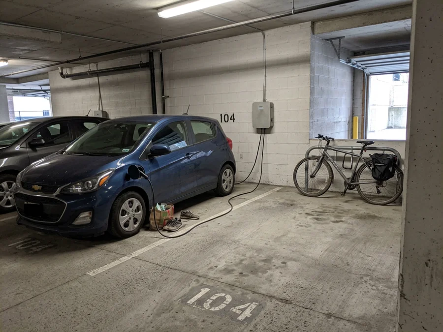 Finished EV charger beside a numbered condo parking stall
