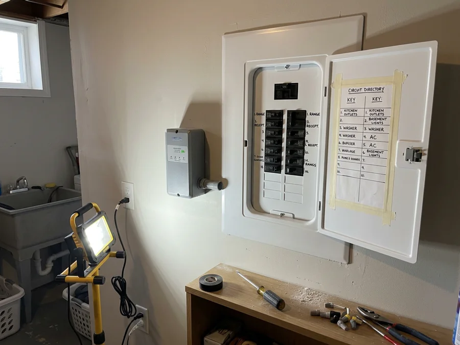 Whole-home surge protector mounted beside a new 200A panel